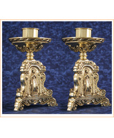 Candelero de mesa en bronce con imágenes grabadas